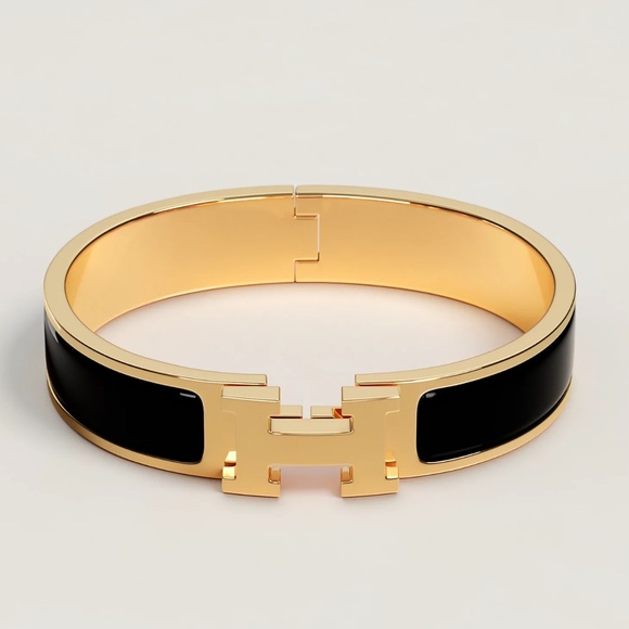 Hermes Jewelry - Hermes small black and gold Clic H bracelet